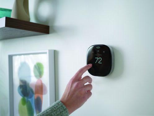 Woman changing the temperature in her Fort Mill home.